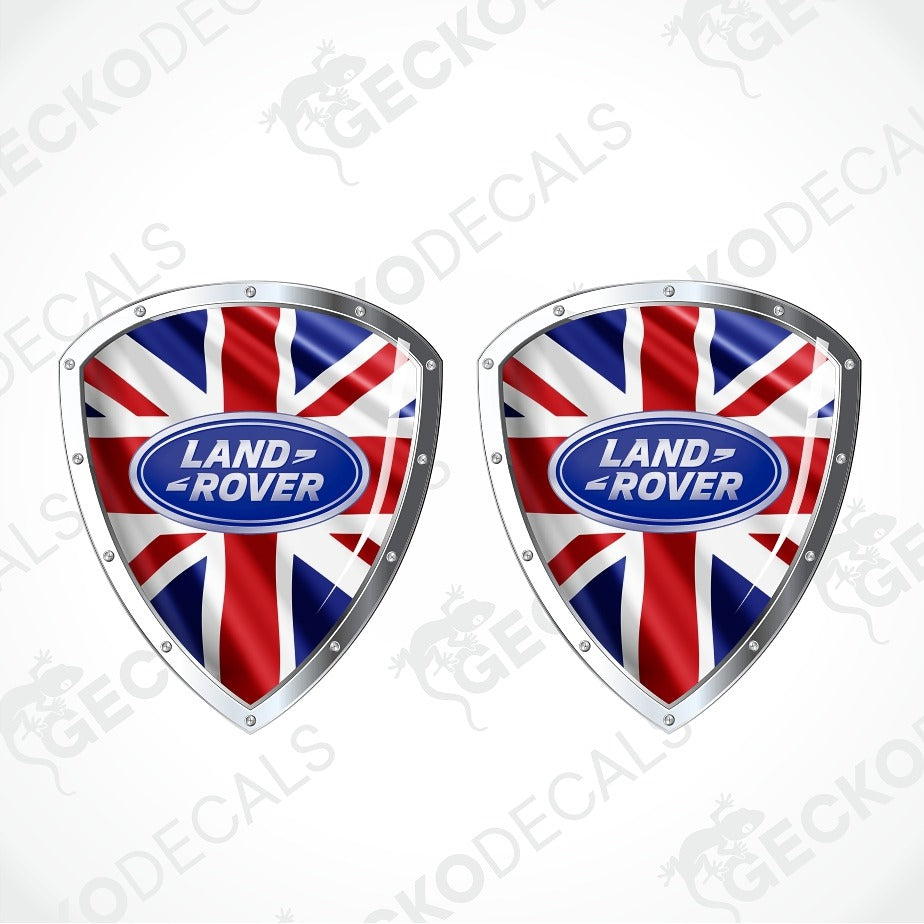 Two shield-shaped decals featuring the Union Jack flag with a central blue oval Land Rover logo, shown on a light gray background with faint GECKODECALS watermarks.
