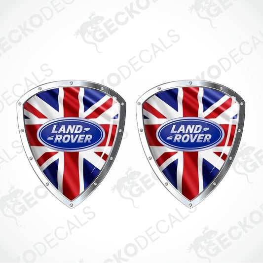 Two shield-shaped decals featuring the Union Jack flag with a central blue oval Land Rover logo, shown on a light gray background with faint GECKODECALS watermarks.