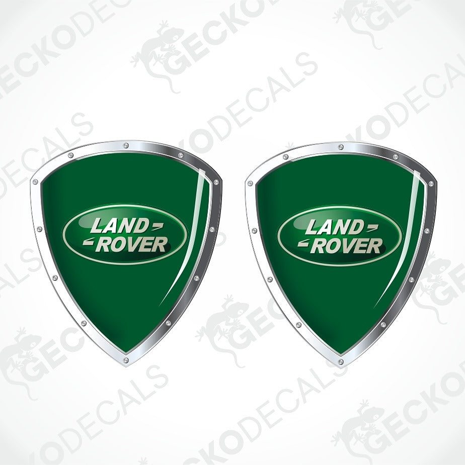 Two green Land Rover shield decals with silver borders and the Land Rover logo, shown on a white background with faint Geekodecals watermarks.
