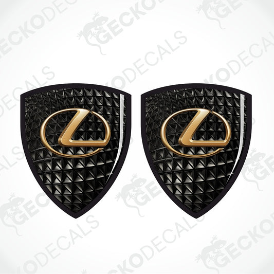 Two black textured Lexus emblem decals with gold Lexus logo centers, displayed side-by-side on a white background with diagonal watermarks.