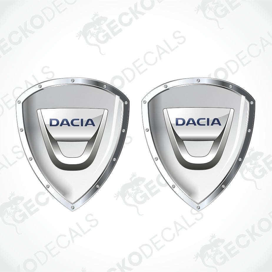 Two metallic silver Dacia shield-shaped decals with blue 'DACIA' lettering, shown on a light gray background with faint watermark text.
