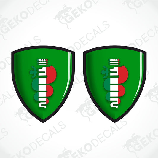 Two identical green shield-shaped decals with a black border, featuring a stylized vertical emblem in green, white, and red on a light gray background with faint GEKODECALS watermarks.
