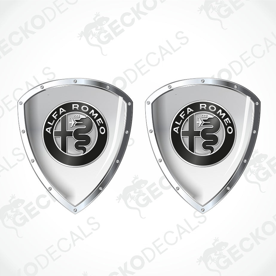 Two metallic silver shield-shaped decals with the black and white Alfa Romeo logo in the center, shown on a light gray background with faint watermark text.