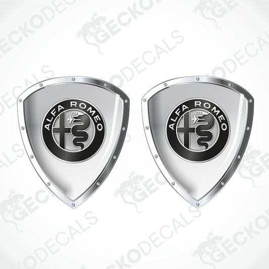 Two metallic silver shield-shaped decals with the black and white Alfa Romeo logo in the center, shown on a light gray background with faint watermark text.