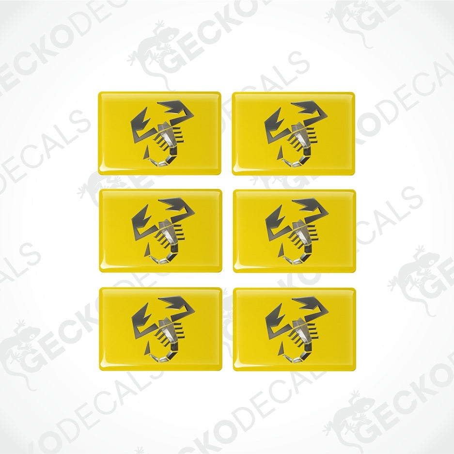 Six yellow rectangular decal stickers arranged in a 2x3 grid on a white background, each featuring a black and gray scorpion graphic.