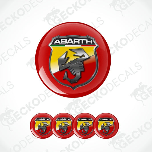 A set of circular Abarth decal stickers, featuring one large glossy red sticker with the Abarth logo and four smaller matching stickers lined up below, on a white background with diagonal watermarks.