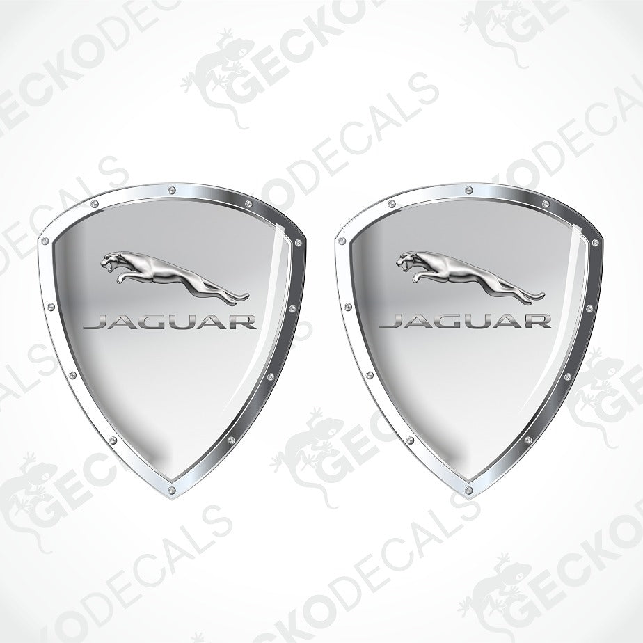 Two silver metallic Jaguar shield-shaped decals with the leaping cat logo and JAGUAR text, shown on a light gray background with faint GECKODECALS watermarks.