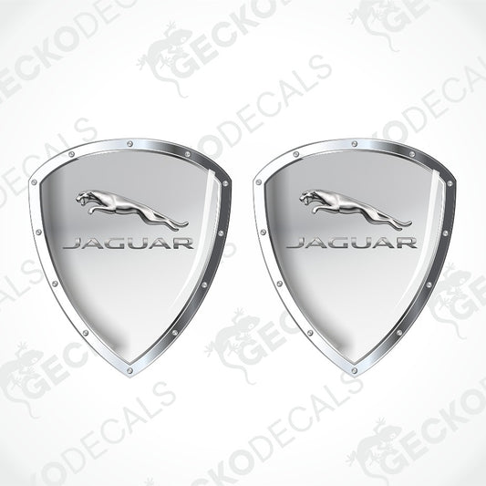 Two silver metallic Jaguar shield-shaped decals with the leaping cat logo and JAGUAR text, shown on a light gray background with faint GECKODECALS watermarks.