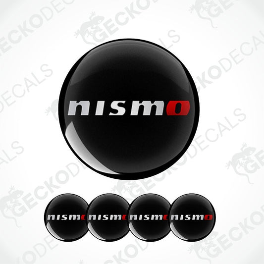 A set of glossy black oval decals featuring the 'nismo' logo in white and red, with one large decal and four smaller ones arranged on a white background with faint Geckodec watermarks.