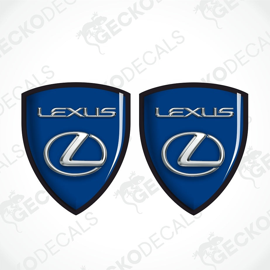 Two blue Lexus shield-shaped decals with black borders, silver Lexus lettering, and the Lexus logo, shown on a white background with faint GECKODECALS watermarks.