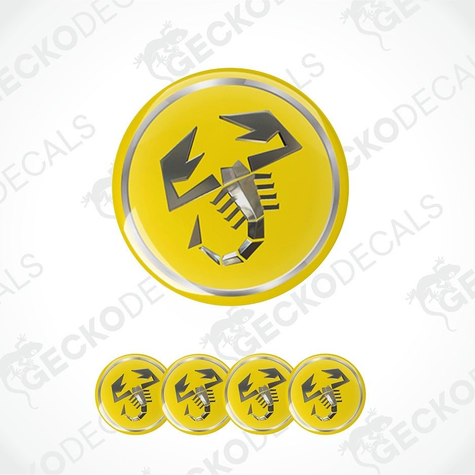 A yellow circular decal or sticker featuring a black scorpion symbol, shown with one large version and four smaller versions along the bottom on a white background with faint Geckodecals watermarks.