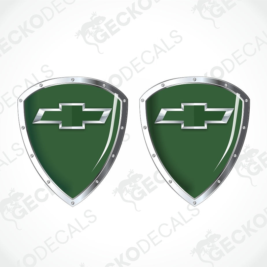Two green shield-shaped decals with silver Chevrolet bowtie logos and metallic silver borders, shown on a white background with diagonal watermarks.