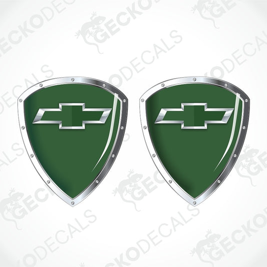 Two green shield-shaped decals with silver Chevrolet bowtie logos and metallic silver borders, shown on a white background with diagonal watermarks.