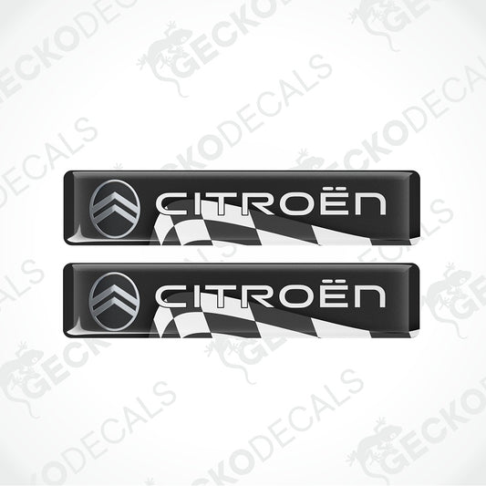 Two black Citroøn door sill decals with the brand's chevron logo and white 'CITROËN' lettering, shown on a light gray background with a faint watermark pattern.