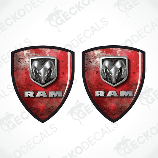 Two identical Ram shield-shaped decals on a white background, featuring a distressed red design, a silver ram head logo, and the word RAM in silver.
