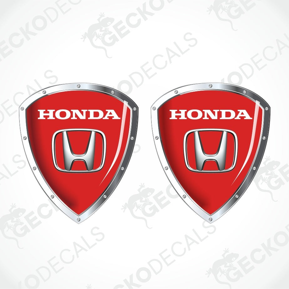 Two red Honda shield-shaped decals with silver metallic borders and the white HONDA wordmark and Honda logo on each, shown on a light gray background with repeated GECKODEC watermarks.