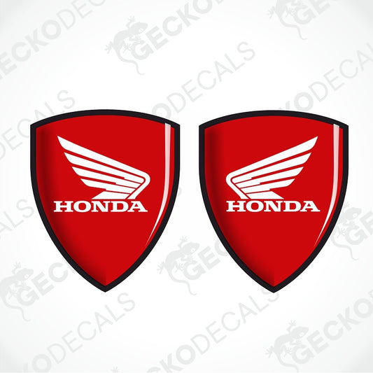 Two red shield-shaped Honda decals with black borders, white wing logos, and white HONDA text on a light gray background with faint GECKODECALS watermarks.