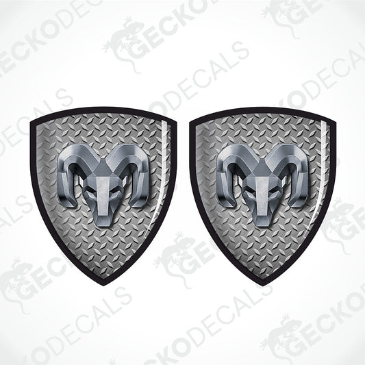 Two identical shield-shaped decal designs on a white background, each featuring a silver ram head over a diamond-plate gray texture with a black border.