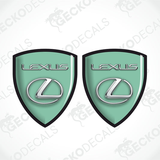 Two mint green Lexus shield-shaped decals with black borders and silver Lexus logos, shown on a white background with diagonal watermarks.