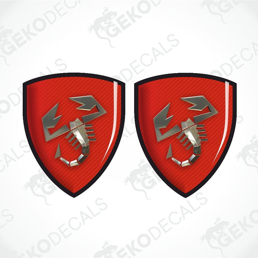 Two identical red shield-shaped decals with a black border and a silver scorpion emblem, shown on a white background with diagonal watermark text.