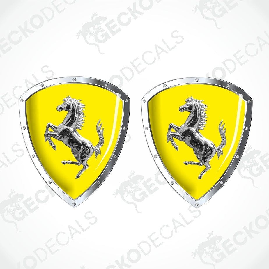 Two Ferrari shield-shaped decals with a bright yellow background and the silver prancing horse logo, shown on a light gray background with diagonal watermark text.