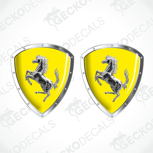 Two Ferrari shield-shaped decals with a bright yellow background and the silver prancing horse logo, shown on a light gray background with diagonal watermark text.