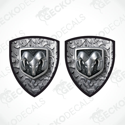 Two identical shield-shaped decals featuring a silver ram head emblem over an ornate gray textured background with black borders, shown on a white background with a faint diagonal watermark.