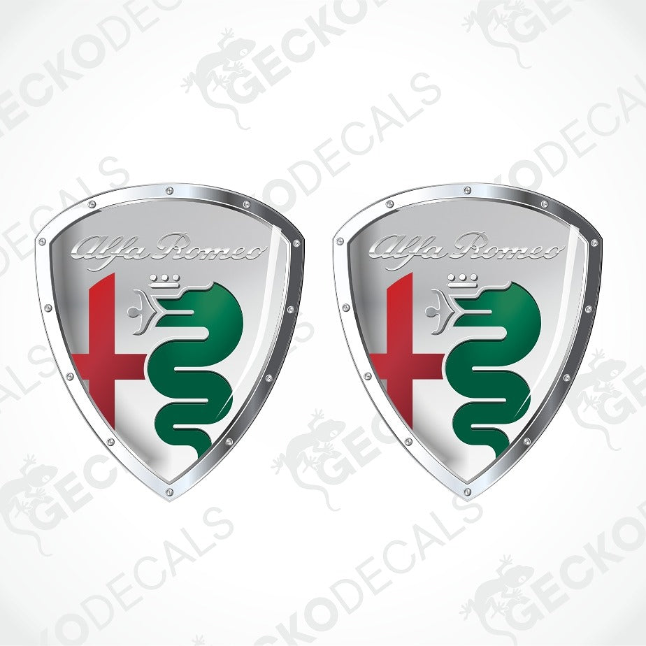 Two identical Alfa Romeo shield-shaped decals on a light gray background with diagonal watermark text. Each shield has a silver metallic border, the Alfa Romeo script logo, a red cross, and a green serpent emblem.