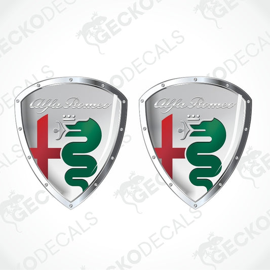 Two identical Alfa Romeo shield-shaped decals on a light gray background with diagonal watermark text. Each shield has a silver metallic border, the Alfa Romeo script logo, a red cross, and a green serpent emblem.