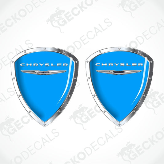 Two blue shield-shaped Chrysler decal stickers with silver borders and the Chrysler logo, shown on a white background with diagonal watermarks.