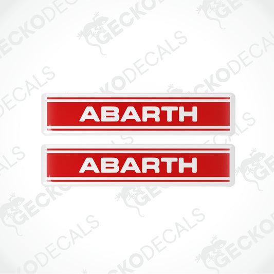 Two red rectangular decals with white borders and the word 'ABARTH' in white capital letters, shown on a light gray background with faint Geckodecals watermarks.