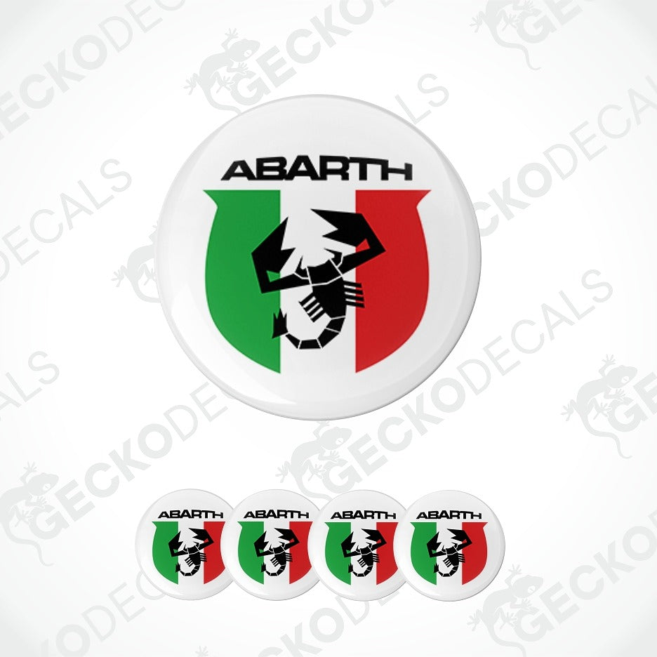 A circular white decal or badge featuring the word ABARTH above a green, white, and red shield with a black scorpion graphic, shown on a light gray background with four smaller identical badges along the bottom.