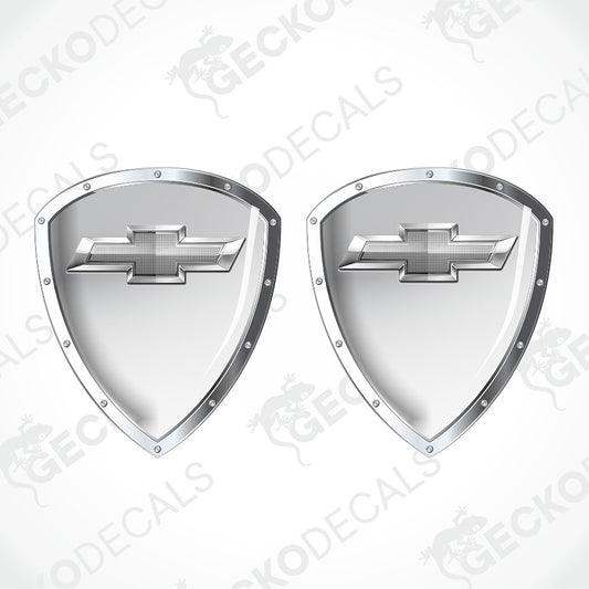 Two metallic silver shield-shaped decals with Chevrolet bowtie logos, shown on a light gray background with diagonal watermark text.