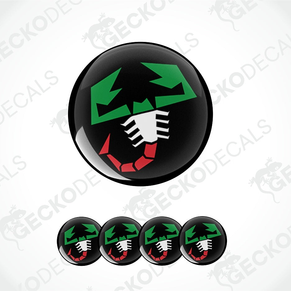 A glossy black circular decal or badge featuring a stylized green, white, and red graphic, shown with five smaller identical decals along the bottom on a light gray background with faint watermark text.