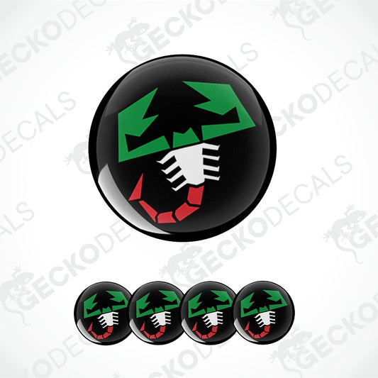 A glossy black circular decal or badge featuring a stylized green, white, and red graphic, shown with five smaller identical decals along the bottom on a light gray background with faint watermark text.
