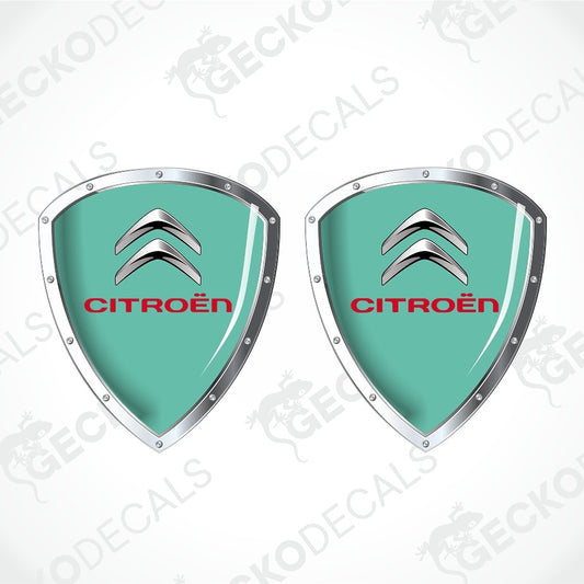 Two identical Citroèn shield-shaped decals on a light gray background with diagonal watermark text. Each decal has a bright yellow center, the silver Citroèn double chevron logo, and the word CITROÈN in red.