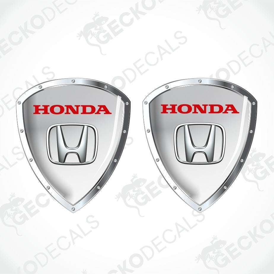 Two silver Honda shield-shaped decals with red HONDA lettering and the Honda logo in the center, shown on a light gray background with a faint GECKODECALS watermark.