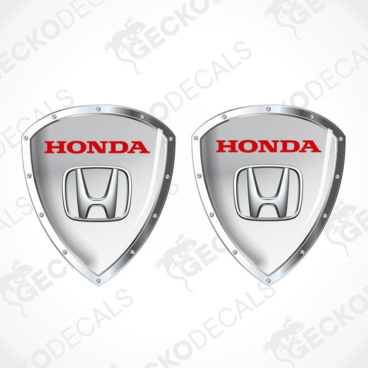 Two silver Honda shield-shaped decals with red HONDA lettering and the Honda logo in the center, shown on a light gray background with a faint GECKODECALS watermark.