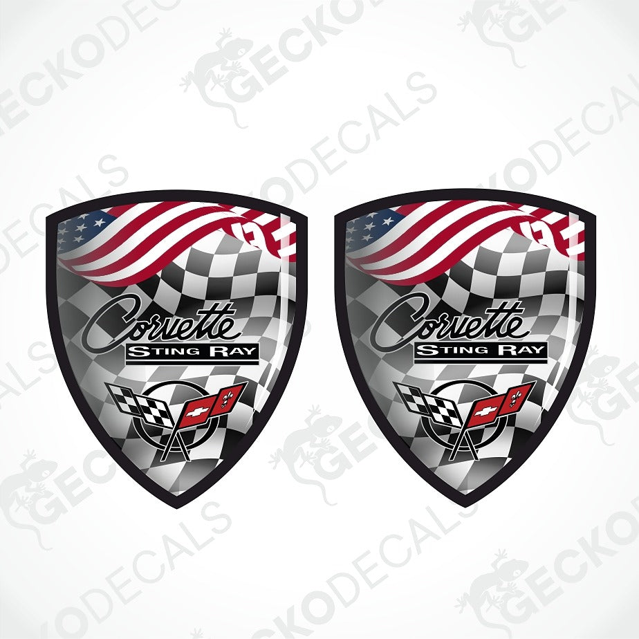 Two matching shield-shaped Corvette Sting Ray decals on a light gray background with faint GECKODE watermarks. Each decal features a black-and-white checkered flag design, the Corvette Sting Ray text, and a red Corvette logo.