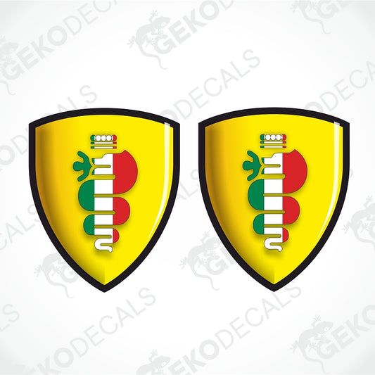 Two identical yellow shield-shaped decals with black borders, featuring a vertical white, red, and green striped emblem with a small crown at the top, shown on a light gray background with faint GEKODECALS watermarks.