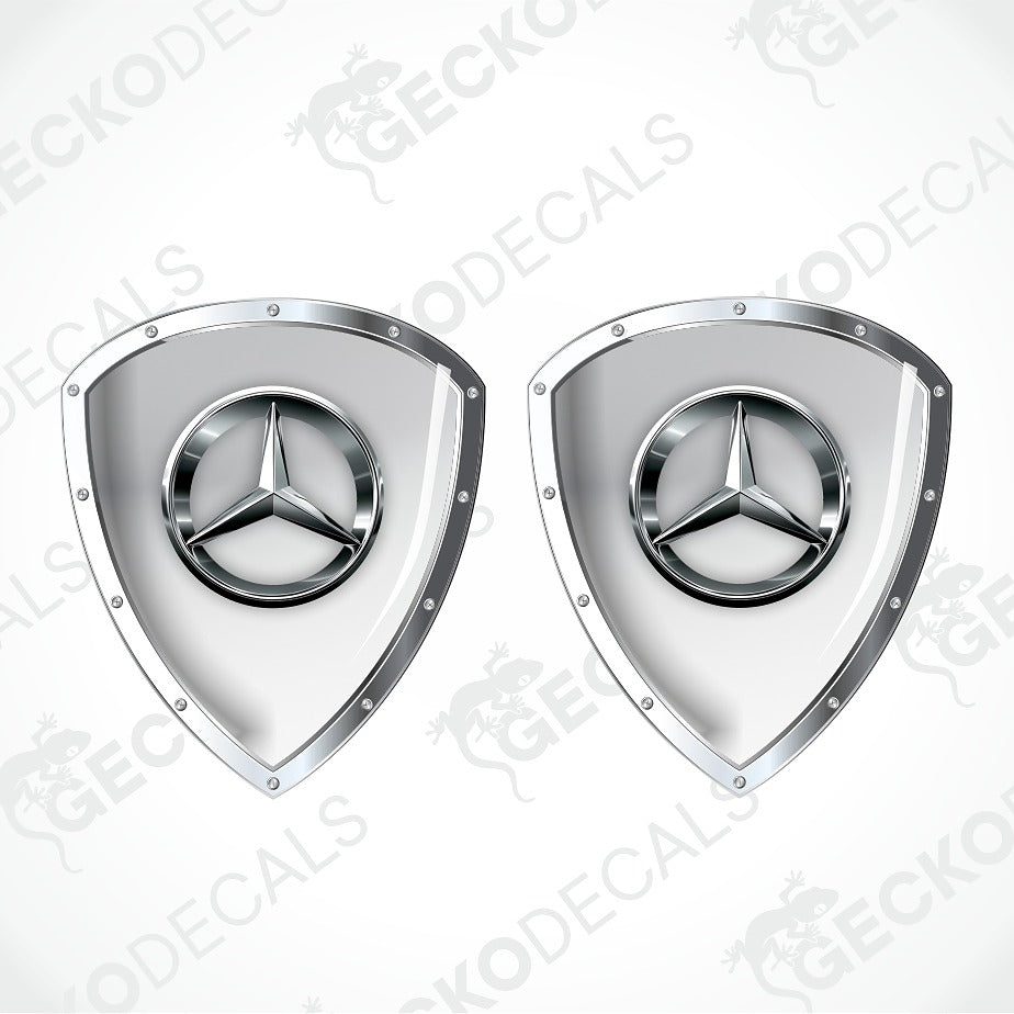 Two identical Mercedes-Benz shield-shaped decals with the three-pointed star logo, shown side by side on a light gray background with diagonal watermarks.