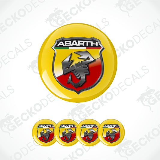 A set of circular yellow Abarth decal stickers, featuring the main Abarth logo in the center and four smaller identical decals aligned horizontally below on a white background with faint watermarks.