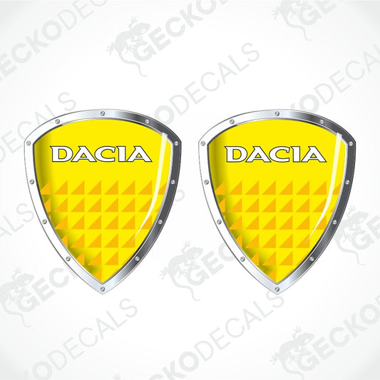 Two identical yellow shield-shaped Dacia decals with silver borders and white lettering, shown on a light gray background with a faint watermark pattern.