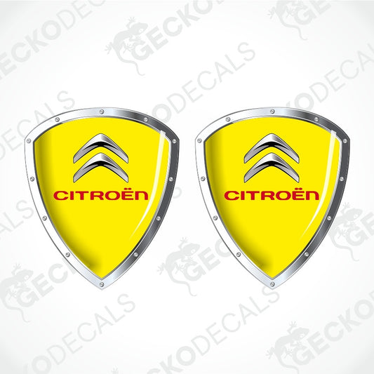 Two identical Citroèn shield-shaped decals on a light gray background with diagonal watermark text. Each decal has a bright yellow center, the silver Citroèn double chevron logo, and the word CITROÈN in red.
