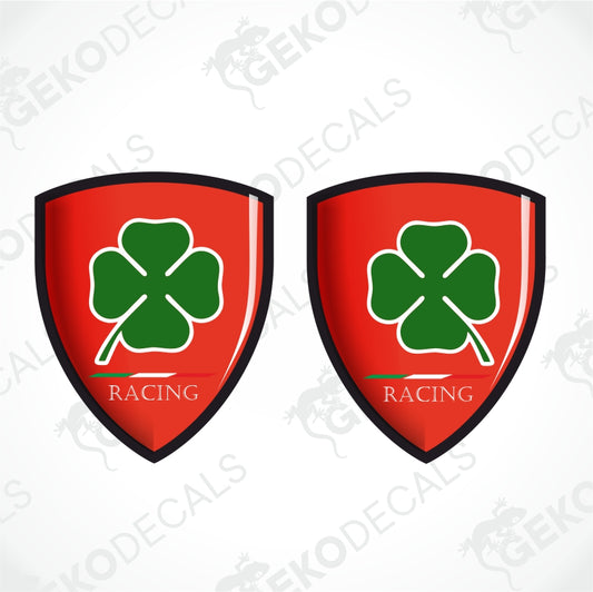 Two identical red shield-shaped decals with a green four-leaf clover and the text 'GEKODE RACING' on a light gray background with faint watermarks.