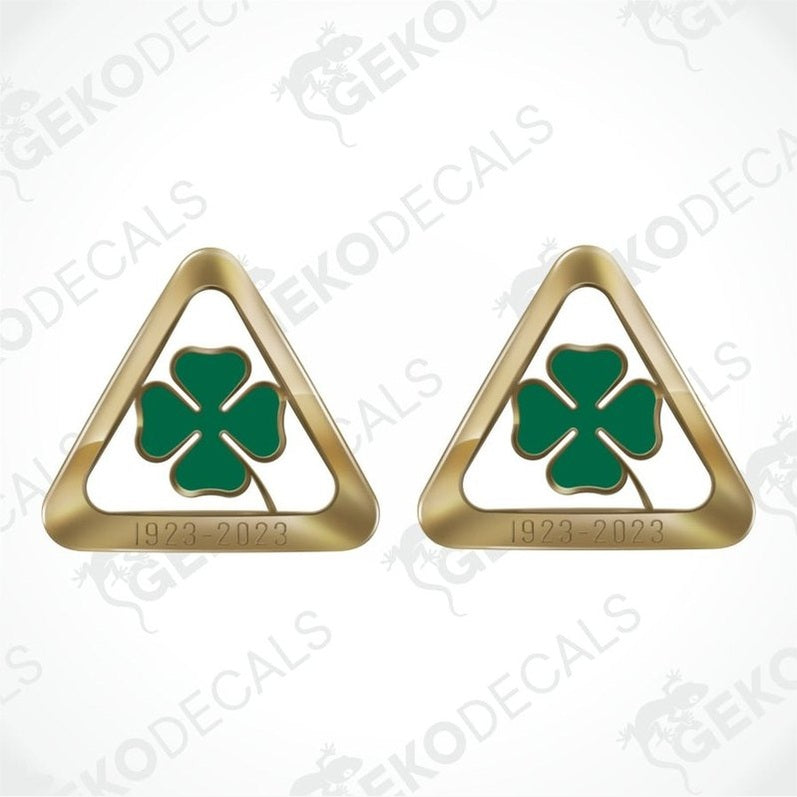 Two gold triangular emblems with green clover symbols on a white background with 'Geckodecals' branding.