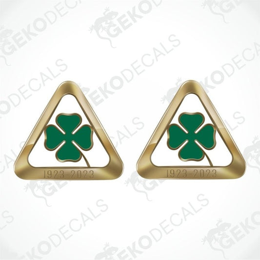 Two gold triangular emblems with green clover symbols on a white background with 'Geckodecals' branding.