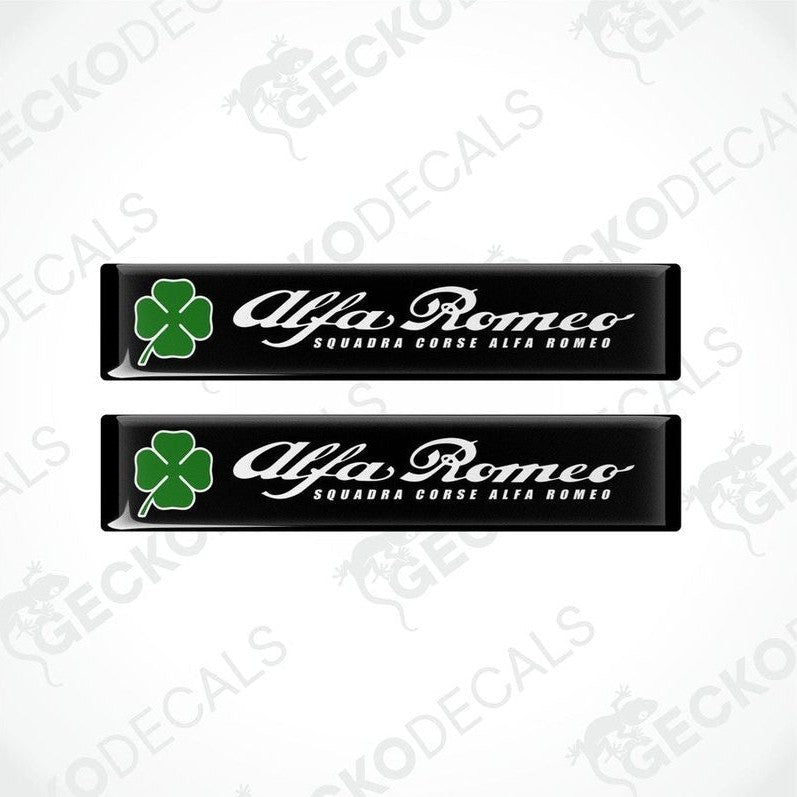 Two black vinyl stickers with green clover designs and the text 'ALFA ROMEO' in uppercase letters.