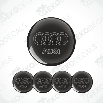 A set of four black vinyl stickers with the word 'AUDI' and the brand's logo on them.