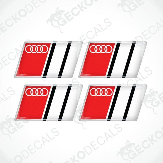 A set of four red, white, and black vinyl stickers with a geometric pattern and the Audi brand logo.